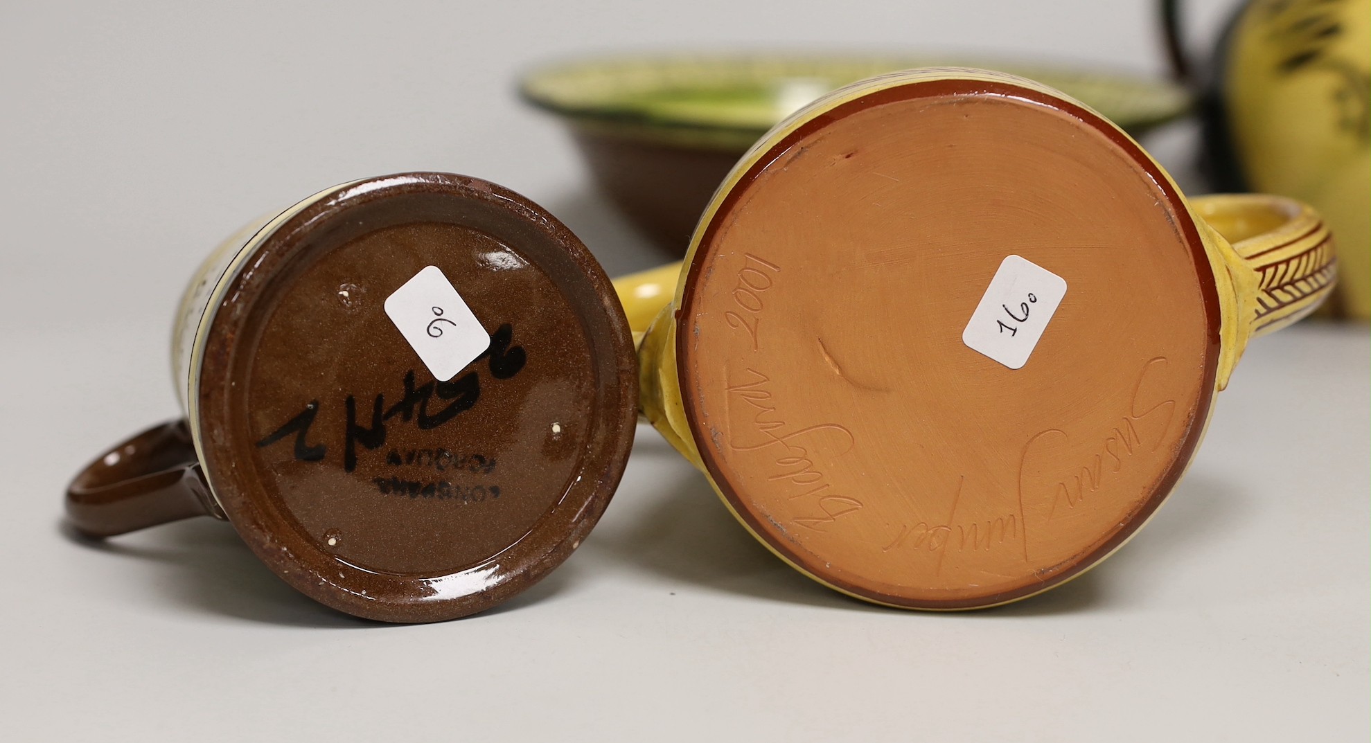 Margaret Brompton studio pottery bowl with insects, together with a slipware jug, a Longpark, Torquay small cockerel jug, and a Susan Juniper slipware jug, largest 21cm diameter, (4)